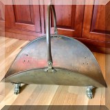 D26. Brass footed basket-shaped log holder. 17.5”h x 23.5”w x 13.5”d - $20 